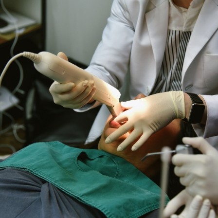 Dentist taking digital impressions of a patient