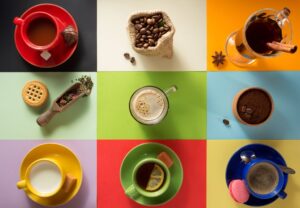 Bird's eye view of several dark drinks and ingredients on differently colored rectangles