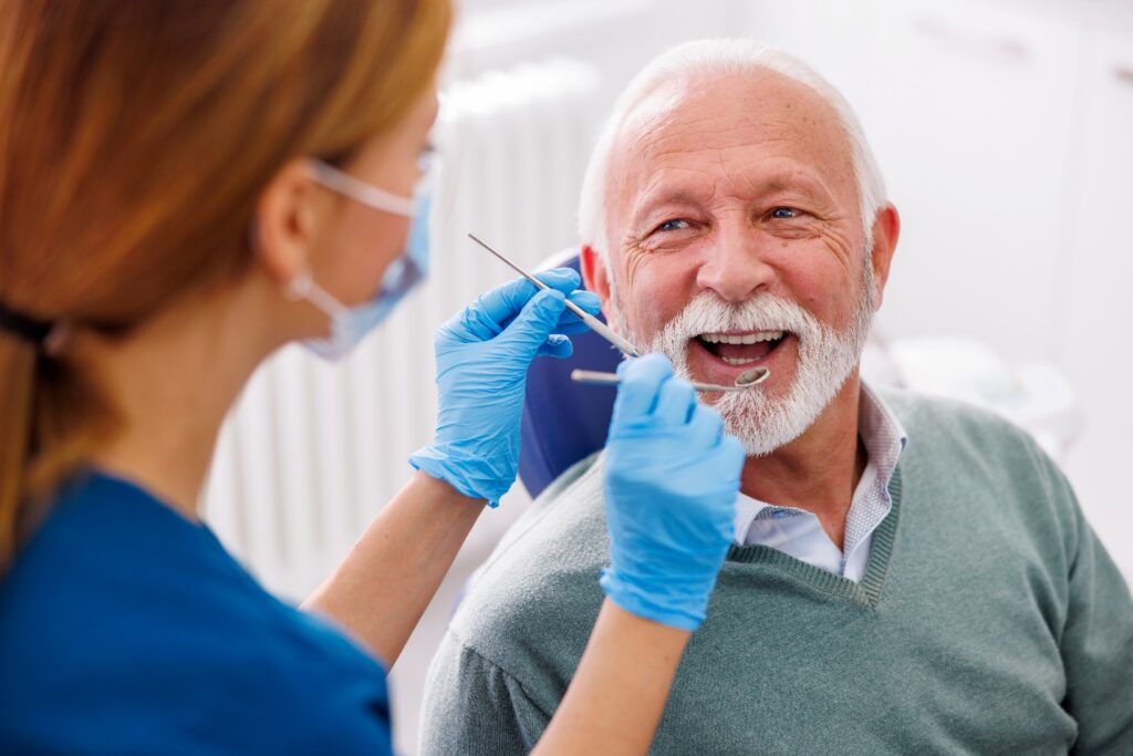 Man smiles at dentist